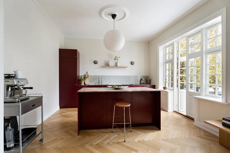 Bespoke kitchen in deep red with herringbone floor