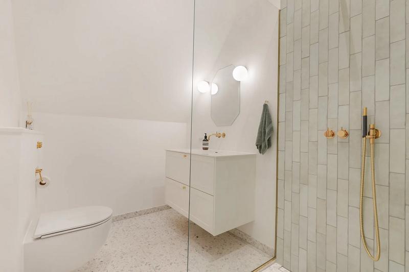 Bathroom with brass fittings and walk-in shower